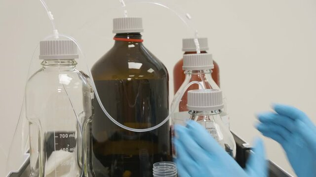 Analytical chemist changes the mobile phase on HPLC system.