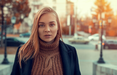 Portrait of a young woman on an autumn background