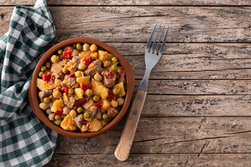 Ropa vieja food in bowl on rustic wooden table. Top view.Copy space