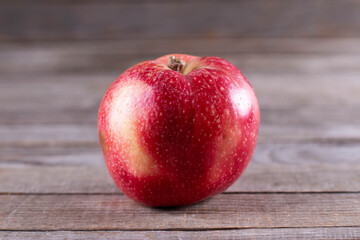 Fresh red apple on a wooden table. Organic food, minimal style, food concept