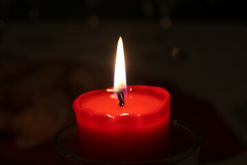 A bright candle shining during Christmas eve 