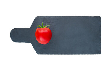fresh tomato on a cutting black board isolated on white background