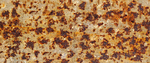 The background image of the iron sheet is rusting caused by prolonged use.Close up of black rust on...