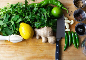 Fresh Ingredients for an asian inspired marinade or sauce, placed on a cutting board with tools