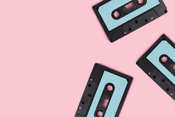 Cassette tapes on a pink pastel background. Creative template with copy space.