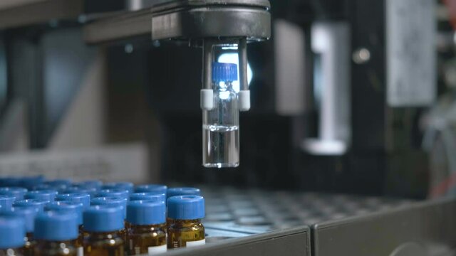 Auto sampler takes a vial and injects a sample into high performance liquid chromatography. 