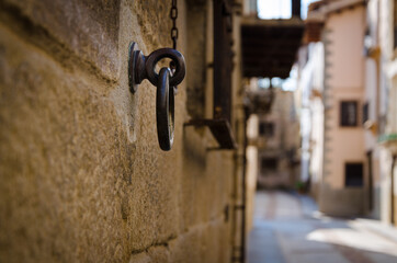 Old rusty ring fixed in stone brick wall