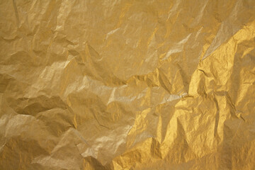 golden crumpled paper texture. paper background.