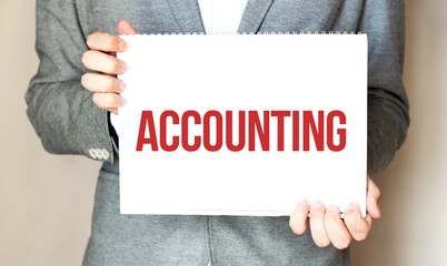 businessman holding a card with text ACCOUNTING