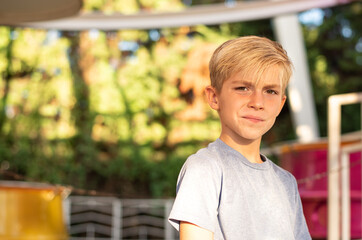 Thoughtful 9 years boy standing at park