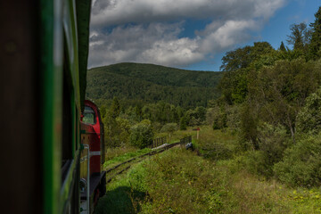 Narrow gauge railway view from train for forests and meadows in Poland mountains - obrazy, fototapety, plakaty