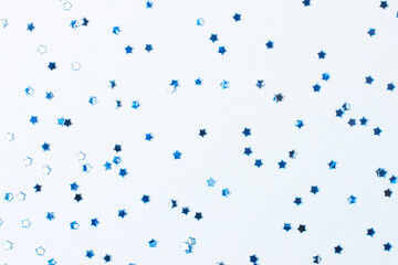 Blue confetti on white. Colorful Christmas or holiday background