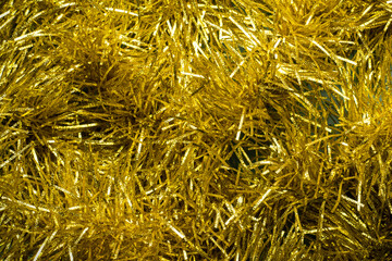 Gold Christmas tree tinsel. Tinsel texture.