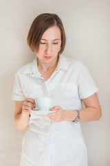 Woman doctor holding a cup of coffee