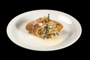 Delicious strudel with condensed milk on a white plate