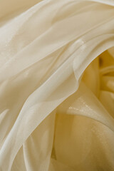 Beautiful texture of yellow silk fabric. Close-up and macro photography. Used as background picture.