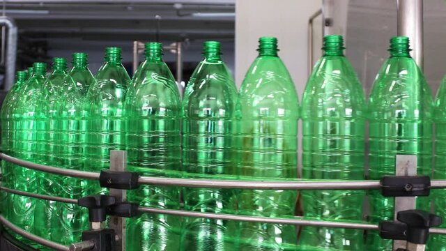Plastic bottle moving in bottling plant at beverage industry
