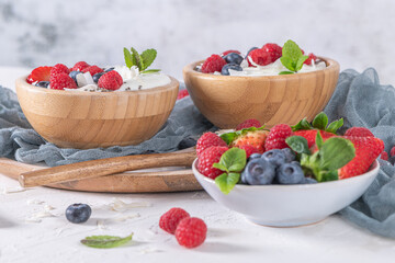 Yogurt and berries for healthy breakfast. Bowl of greek yogurt with raspberry, blueberries and strawberries