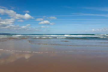 Waves in the ocean on the beach, blue sky