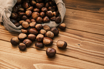 Close up shot of chestnut in the linen bag on a wooden table 