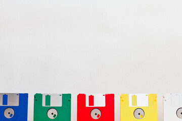 Multi-colored floppy disks in one row on a white background