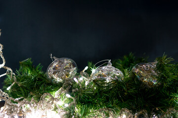 Christmas decoration background with spheres, lights and Christmas plant.