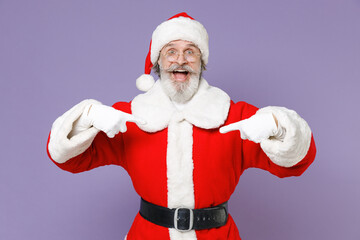 Excited Santa Claus man in Christmas hat red suit coat white gloves glasses pointing index fingers on himself isolated on violet background studio. Happy New Year celebration merry holiday concept.