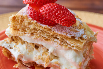 Tarta Milhojas in spanish - a pastry containing layers of puff pastry, pastry cream, strawberries, manjar and sugar. Also called mille feuilles or napoleon cake