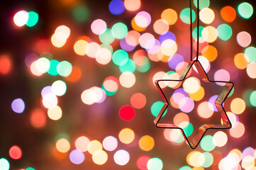 Star for home decoration on the background of Christmas lights. defocus christmas lights.