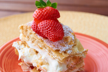 Tarta Milhojas in spanish - a pastry containing layers of puff pastry, pastry cream, strawberries, manjar and sugar. Also called mille feuilles or napoleon cake