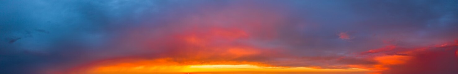 Bright and intense Panorama twilight cloudy sky. Evening background image