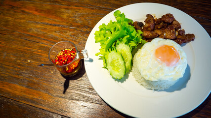 Fried pork with garlic and fried egg with fish sauce chili paste.