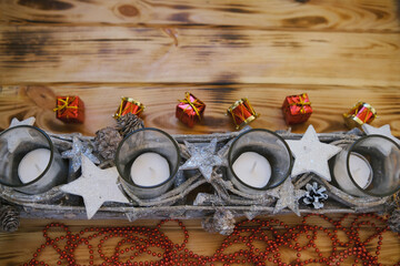 Christmas candles with new year accessorise  on the warm wooden table.