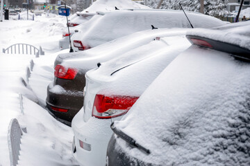 The snow-covered Parking lot with cars. Selective focus.