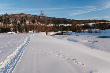 Fototapeta na wymiar Open water in winter. Winter landscape on the river. Snow lies along the banks of the river.