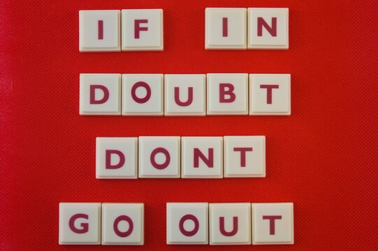 Covid Prevention Message, If In Doubt Don't Go Out On A Red Background 