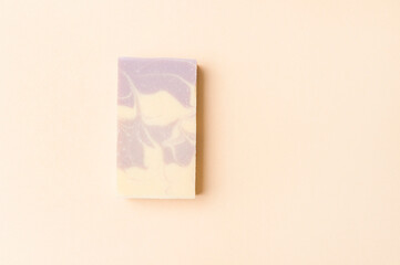 Hand made soap bar on camel color background, top view. Space for text. Zero waste concept