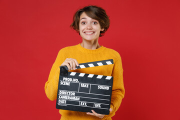 Smiling pretty charming young brunette woman 20s wearing casual yellow sweater standing holding...