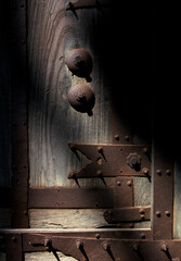 城門に施された鉄の鋲と錆びた飾り金具