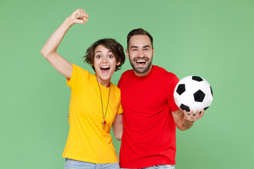 Laughing funny young couple friends sport family woman man football fans in t-shirts cheer up...