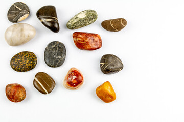 colored stones on white background with space