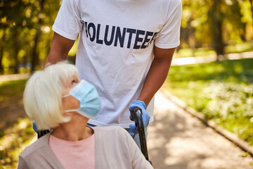 Lightly dressed volunteer aiding an elderly patient