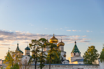Fototapeta na wymiar Holy Trinity Ipatiev monastery under a blue sky at dawn in the city of Kostroma on the Bank of the Kostroma river. Golden ring of Russia.