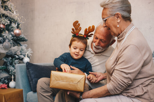 Grandson getting present from his grand parents