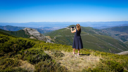 woman taking photos in the valley of silence in the province of Leon