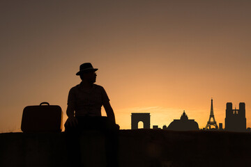 silhouette of man with suitcase at sunrise