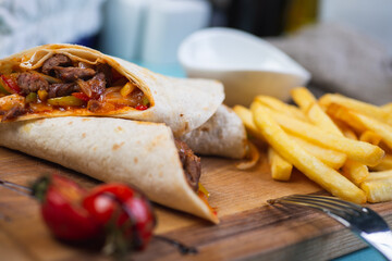 Traditional Caucasian meat in a tortilla with spices and seasonings is wrapped in a tube.