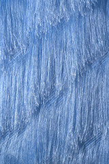 Horizontal blue background from fabric with a long thread, the effect of fur.