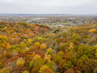 autumn landscape in the mountains Heading down to a cityscape blow with more mountains in the distance.