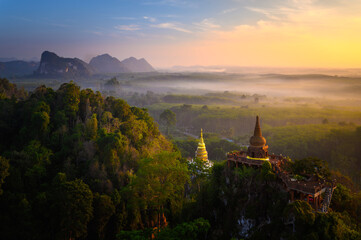 View of Buddhism temple Thamma Park padoga on hill at sunrise in Ban Khao Na Nai village in Phanom, Surat Thani, Thailand